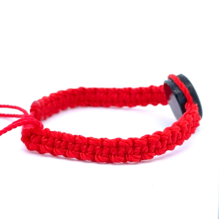 Handmade red Witches Knot Bracelet with wood charm symbolizing faith, unity, and divine protection.